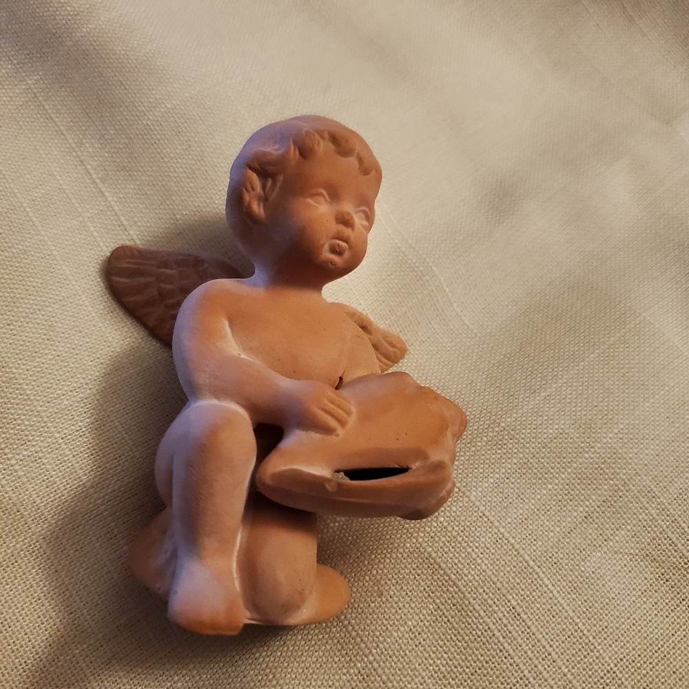 Vintage terracotta cherub with shell